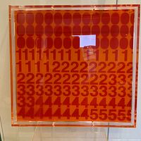 Front view of square orange acrylic panel with red repeating numeral grid