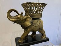 Front view of the vintage brass elephant planter showing detailed design and planter basket on elephant's back.