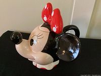 Side perspective photo of the Minnie Mouse teapot showing the facial details and the spout formed as the nose.