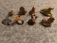 Full view of 8 Red Rose Tea Wade animal figurines on carpet, showing variety of dog, bird, deer, turtle and other animal figures.