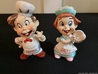 Front view of both shakers labeled Peppy and Salty, showing detailed cartoon character designs and colors.