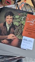 Close-up photo of videodisc sleeve showing a portrait and 'American Art from the National Gallery of Art' label alongside some condition details.