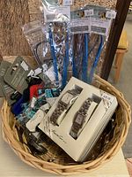 Full basket view showing assortment of jewelry, hand sanitizer pouches, and boxed wristwatches