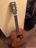 Full view of Aria acoustic guitar showing headstock, fretboard and body