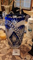 Front view of cobalt blue vase showing clear-cut pinwheel and starburst design