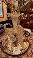 Full front view of glass epergne centerpiece on metal stand