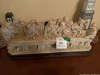 Frontal view of entire ivory-tone resin Last Supper group on wood base