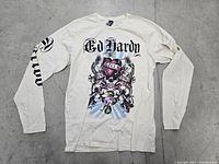 Front view of white Ed Hardy XL sweatshirt showing full graphic print and sleeve text design