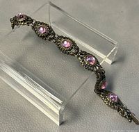 Photo showing full length of the vintage pink crystal bracelet arranged on clear acrylic display stand.