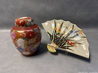 Photo showing both the fan-shaped plate and the ginger jar side by side from a front angle.