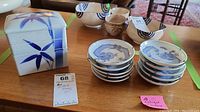 Photo showing ten small 4-inch collector plates stacked and the porcelain trinket box