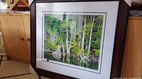 Full view of framed print with white mat and dark brown frame