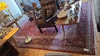 Wide view of rug under furniture showing overall pattern and condition