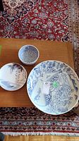 Overview of two platters and bowl on table surface