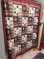 Full view of Americana patchwork shower curtain hanging on a rod indoors