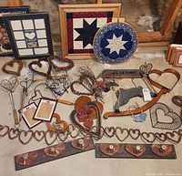 Overview of vintage Americana decor items including framed quilt squares, heart-shaped wreaths, wooden wall hangings, and decorative hooks.