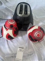 Darth Vader toaster from front with two spherical Sphero robot droids next to it showing colors and details, with MaxSold lot tag.