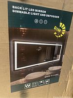 Box label showing ‘Back Lit LED Mirror’ graphic with dimmable light and defogger icons