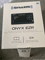 Front view of SiriusXM Onyx EZR Satellite Radio retail box highlighting model name and main features such as split-screen mode and music channel creation.