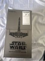 Star Wars Propel T-65 X-Wing box front with basic branding and X-Wing schematic graphic.
