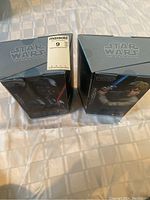 Front view of Star Wars The Black Series Hyper Real Darth Vader and Luke Skywalker sealed boxes.