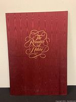 Closed maroon folder titled 'The Romance of Nature' in gold script lettering.