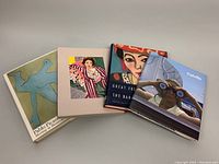Four vintage art reference books laid out showing covers related to Picasso, Matisse, Colville, and French paintings.