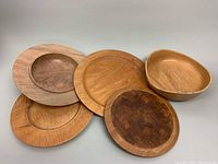 Overview photo of all five handcrafted wooden serving pieces showing various sizes and wood grains.