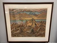 Full view of framed print titled "Summer at Pangnirtung" by A.Y. Jackson, showing landscape of rocky shore with two figures and mountainous background in earthy tones