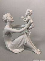 Front angle of bisque porcelain figurine depicting woman and child