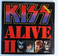 Front cover of Kiss Alive II double album vinyl LP, showing bold red, blue and yellow lettering with portraits of the four band members in makeup.