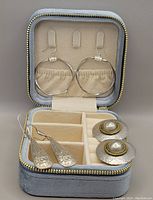 Three pairs of sterling silver earrings inside a soft zippered velvet travel/storage box with adjustable compartments, LA KAISER brand.