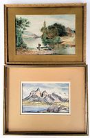Photo of both framed watercolour paintings, showing the riverside scene with vintage brown mat and the mountain scene with light tan mat, both under glass.