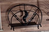 Black iron magazine holder featuring a crescent moon cutout