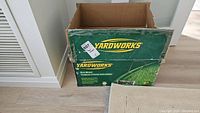 Box of Yardworks reel mower with visible wear, showing branding and mower image.
