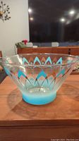 Side view of clear glass bowl with turquoise and gold atomic boomerang pattern, showing the conical shape and gradient blue base.