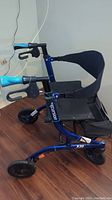 Side view of blue Argo Excursion X20 folding walker showing seat, brakes, and wheels