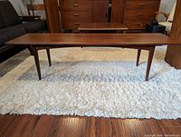 Front view showing overall table profile and walnut grain.