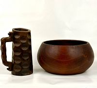 Teak bowl and wooden beer stein mug side by side on white background showing relative size and shape