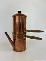 Side view of copper flip drip espresso coffee maker showing two wooden handles and spout