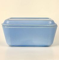 Side view of vintage Pyrex Delphite blue rectangular storage dish with fitted lid, showing overall shape and color.
