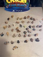 Overview of all 42 Wade England Red Rose Tea animal figurines arranged on a table, showing various animals and character figures in natural colors.