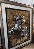 Front angled view showing the detailed 3D metal artwork of Napoleon on horse, 41x49 inch frame with minor damage on top left corner.