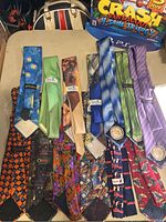 Overview of 13 vintage ties arranged on a surface showing color and design variety