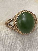 Front view showing green cabochon and rope bezel