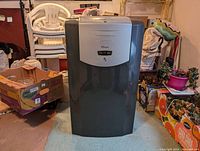 Frontal view of portable air conditioner unit showing control panel and overall unit shape.