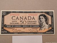 Full front view of 1954 Canadian $50 banknote showing Queen Elizabeth II portrait and serial number.