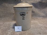 Front view of the beige ceramic pickling jar with Sunburst Ceramics Ltd branding and number 2 visible on side.