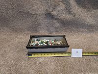Front angle view of the rectangular ceramic planter showing length measurement around 12 inches and marbles inside.