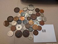 Overview photo showing around 40 mixed coins and tokens in various metals, sizes, and conditions.